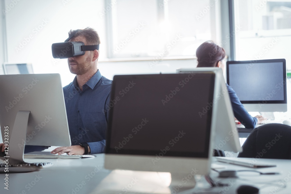 Mature student in virtual reality headset using computer Mature student in virtual reality headset using computer