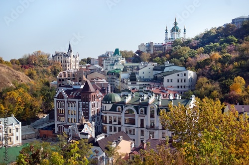 Kiev city. Old houses on the Vozdvizhenska street and St. Andrew's Church against the blue sky. Capital of Ukraine - Kyiv. photo