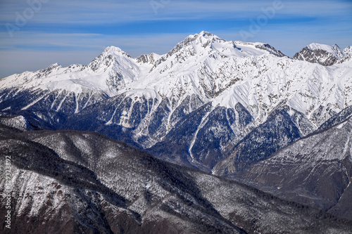 Beautiful mountain scenic winter landscape of the Main Caucasian ridge with snowy peaks and blue sky © Wilding