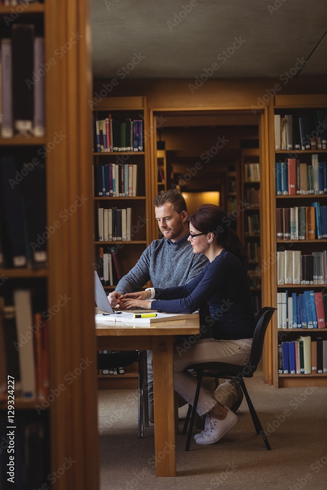 Mature students working together in college library Mature students working together in college library