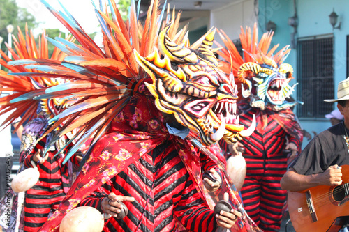 Diablicos dancing in the street in a Corpus Christi celebration