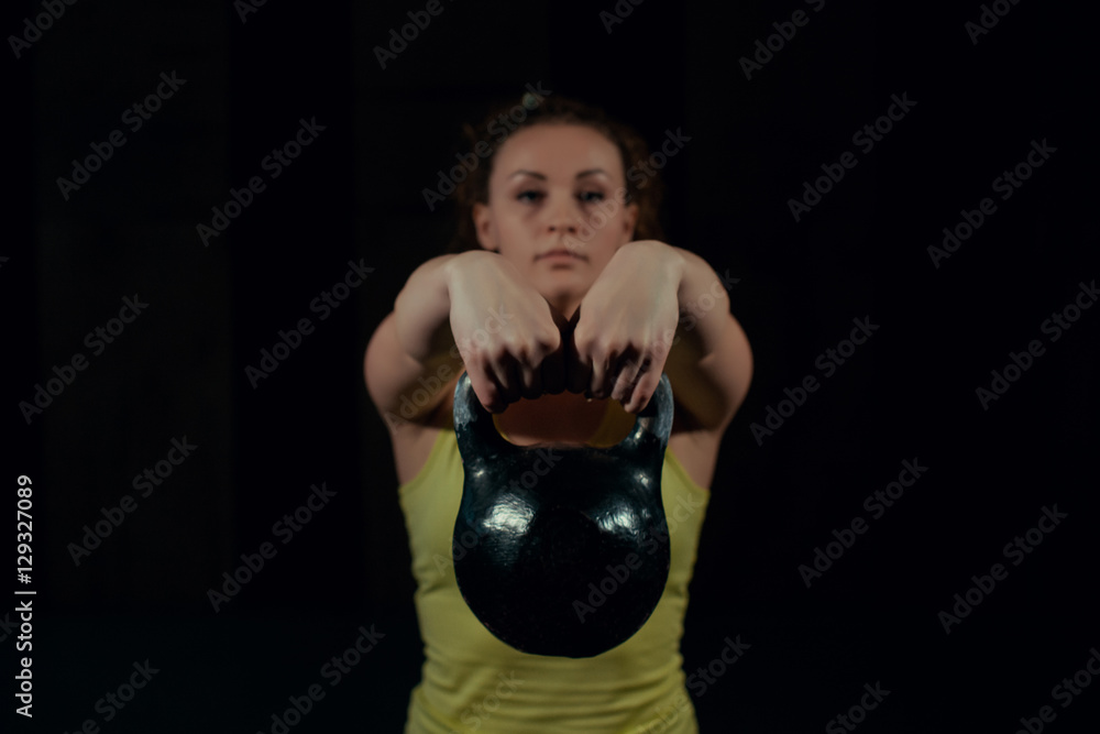 Girl waving weights in the gym. Girl waving weights in the gym.