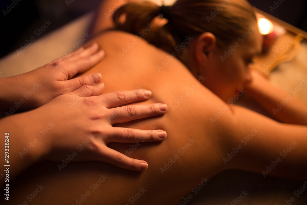 Masseur make spa procedure by candle light for woman Masseur make spa procedure by candle light for woman