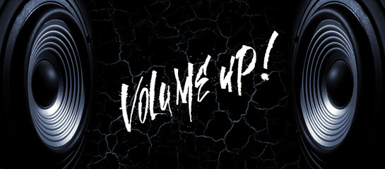 Black and white image of a two membranes sound speakers on a black background with cracks. Photos contains handwritten text " Volume up'