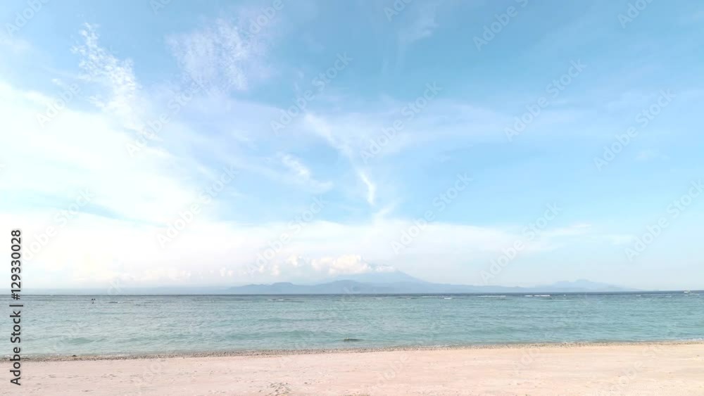 Tropical scene Time Lapse. Ocean, beach, sky, running clouds, volcano Agung - amazing scene. Island Nusa Lembongan, Indonesia. Tropical scene Time Lapse. Ocean, beach, sky, running clouds, volcano Agung - amazing scene. Island Nusa Lembongan, Indonesia.