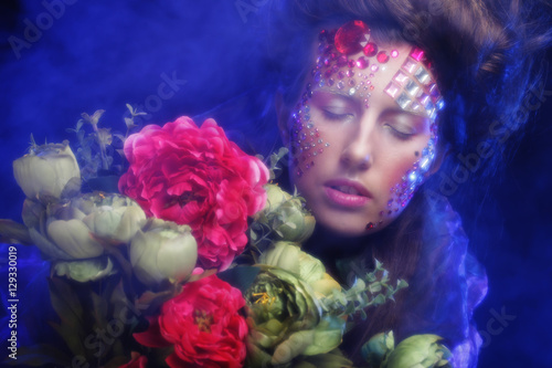 woman in creative image with big flowers.