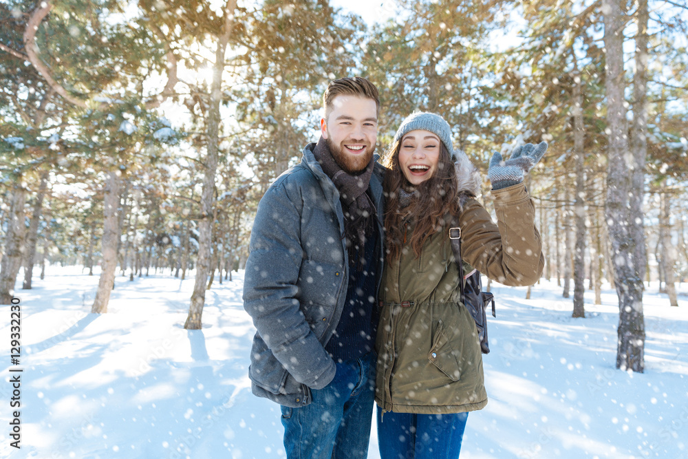 Laughing couple standing in winter park Laughing couple standing in winter park