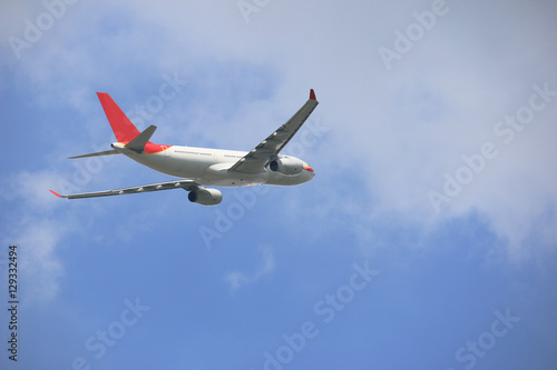 side of commercial plane on blue sky