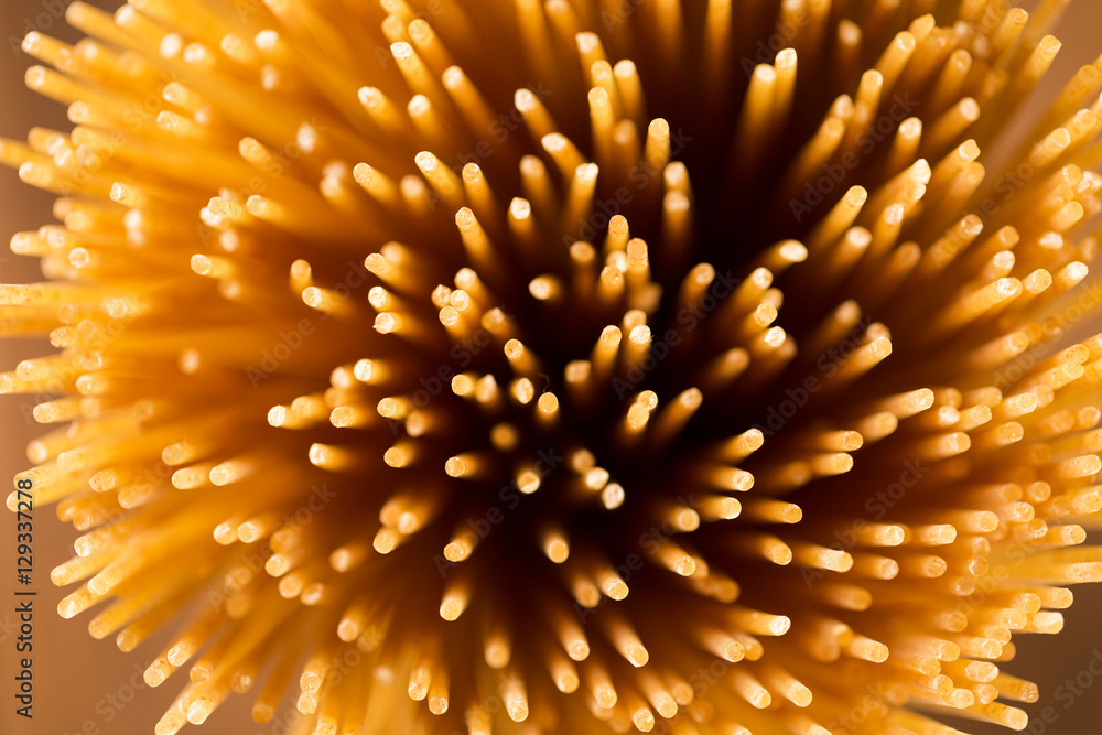 Obraz premium Yellow long spaghetti integral on a rustic background. Yellow it