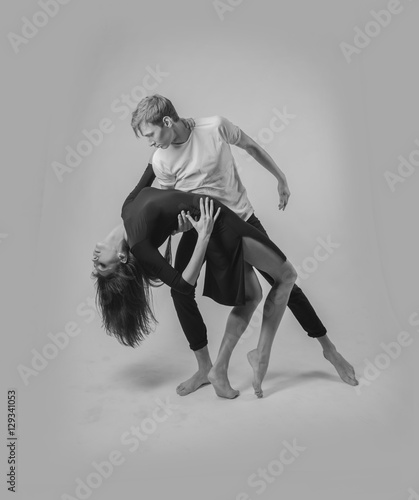 couple dancing on a white background. A guy and a girl in dance movement black and white color
