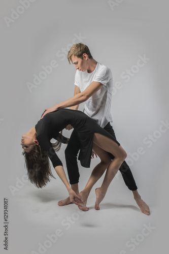 couple dancing on a white background. A guy and a girl in dance movement