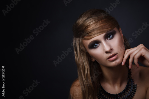 Studio closeup beauty portrait of attractive woman with smoky ey