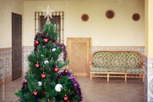 A pretty artificial Christmas tree with some Christmas decoratio