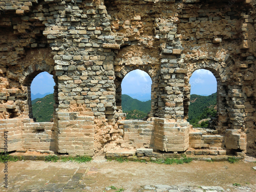 Ancient Great Wall of China section with windows and crumbling brick