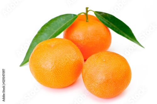 orange fruits with leaf on white