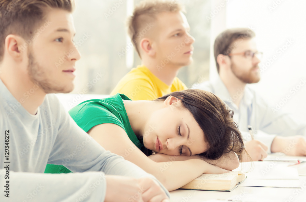 Girl sleeping in the classroom during the lessson