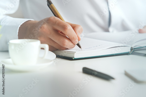 Man writing in organizer