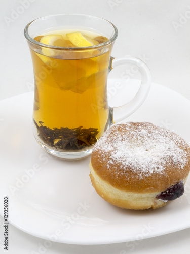 Transparent Cup with Tea and a Donut