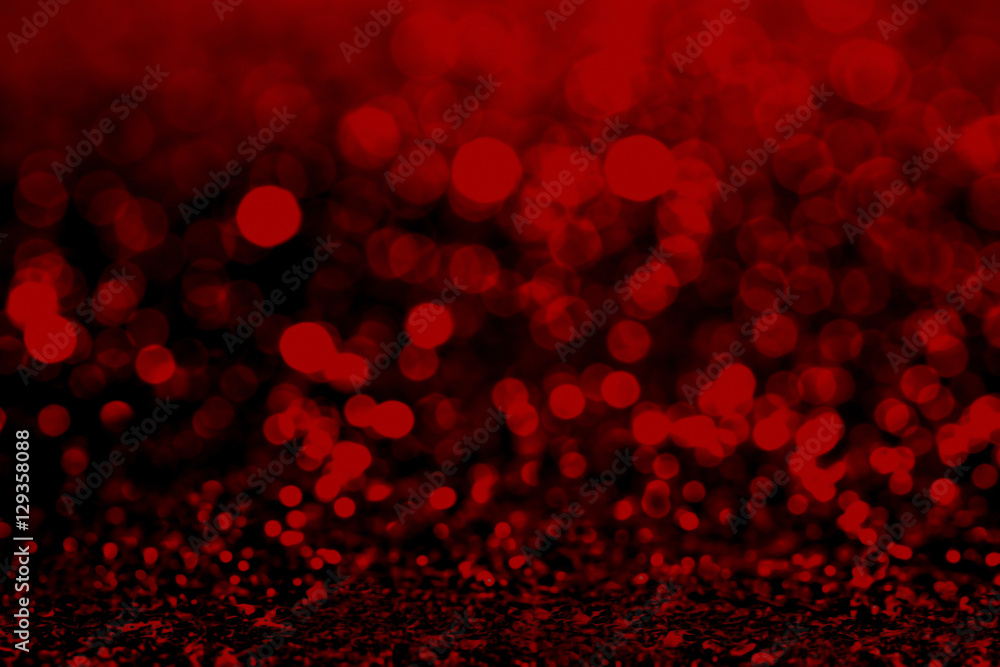 Abstract dark red glitter background with shining light and soft bokeh, festive colors