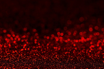 Abstract dark red glitter background with shining light and soft bokeh, festive colors