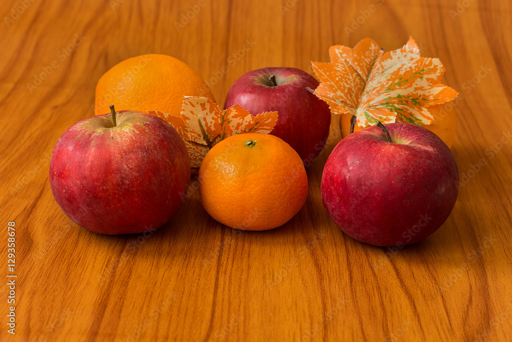 Apples and Oranges on brown background Apples and Oranges on brown background