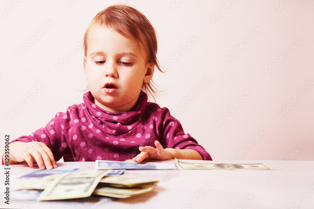 Baby girl counting money. Dollars. success, wealth management. ( Baby girl counting money. Dollars. success, wealth management. (