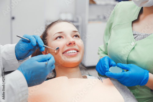 Fototapeta Naklejka Na Ścianę i Meble -  The girl with a beautiful smile at the reception  the dentist.
