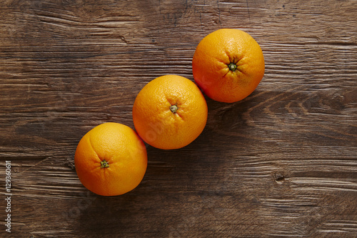 thre organic oranges forming ascending line photo