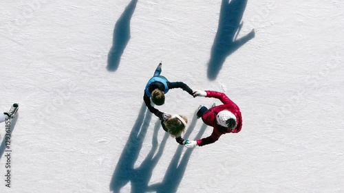 Aerial view of ice skating family outdoor, ice rink Medeo