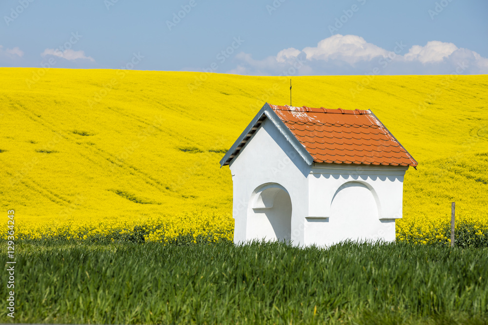 white chapel in colored fields