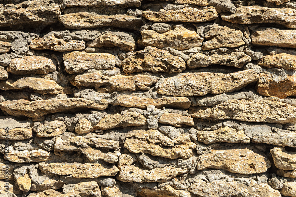 Fototapeta premium Wall of rough stones shell