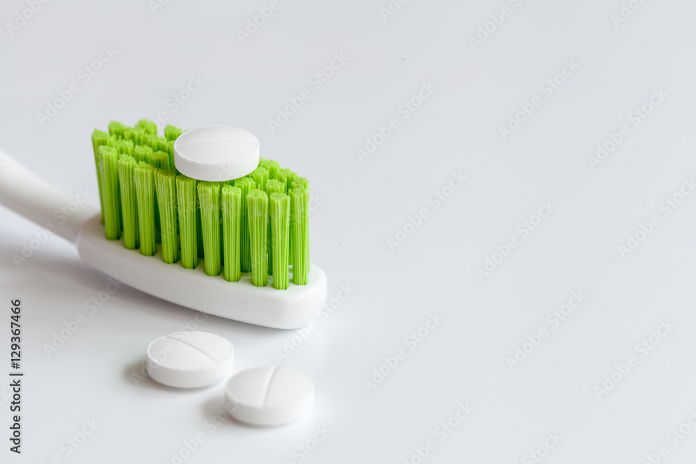 concept toothache with toothbrush and pills at white background concept toothache with toothbrush and pills at white background
