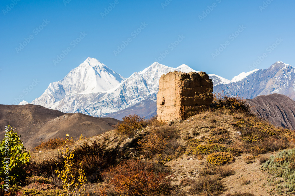 Ancient watch tower with mountain scenery.