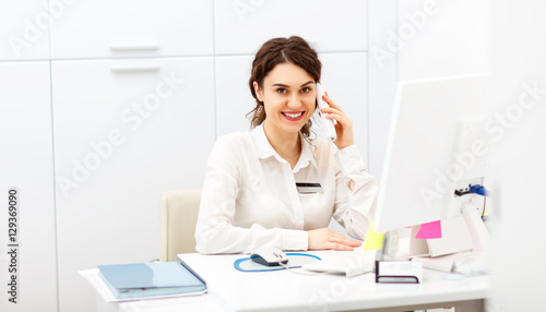 friendly woman behind reception desk administrator