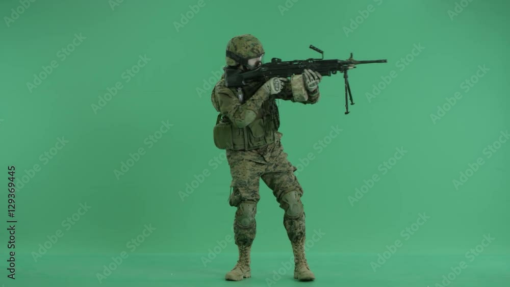 serviceman standing and targeting around at green screen serviceman standing and targeting around at green screen