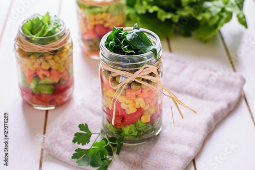 Homemade healthy salads with vegetables in jar