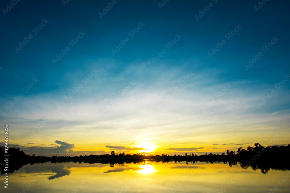Beautiful sunset over lake with blue sky