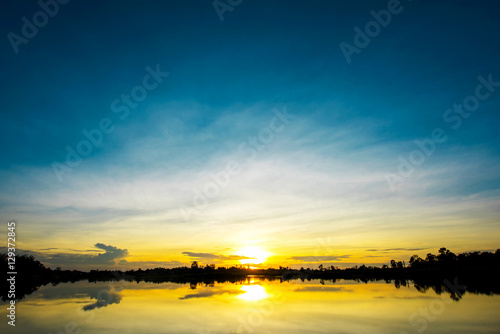 Beautiful sunset over lake with blue sky