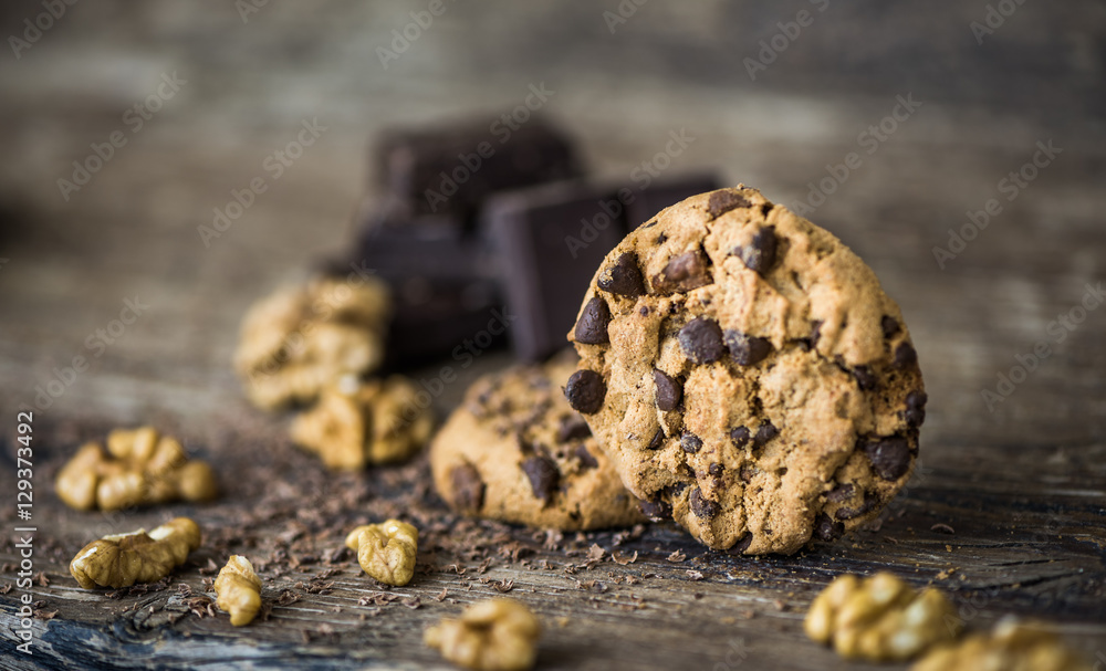 Fototapeta premium Chocolate Chip Cookies and Walnuts on Wooden Rustic Background