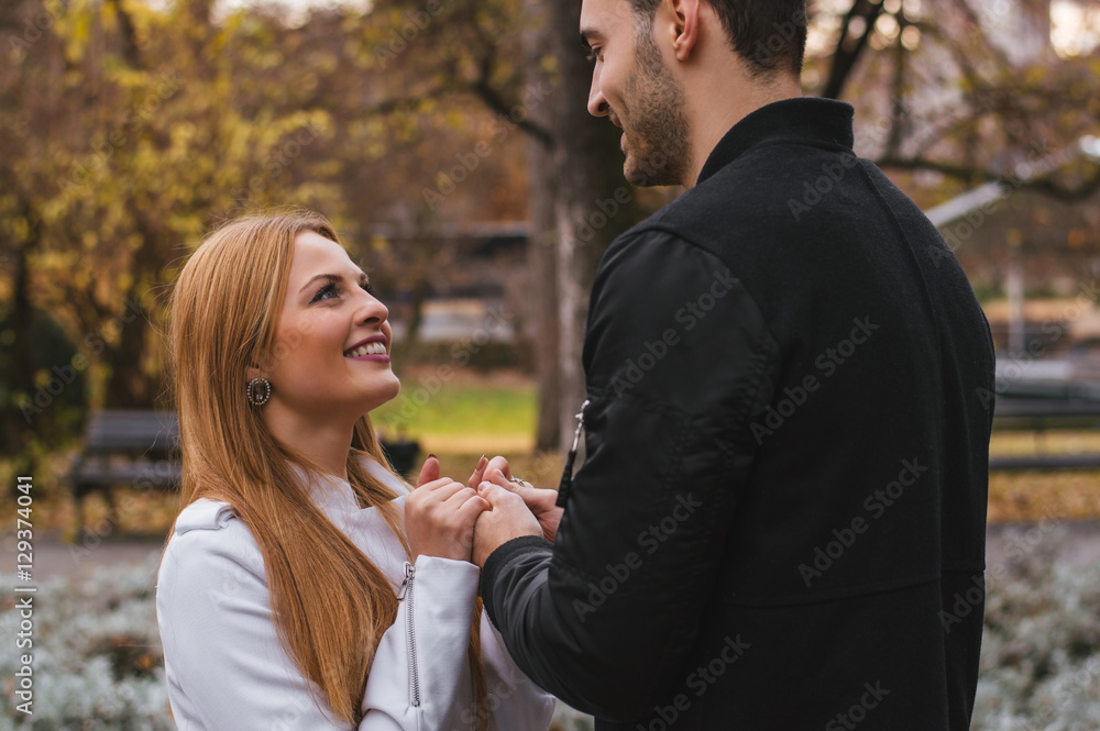 Fototapeta premium She telling something to him, both are smiling. The couple in lo