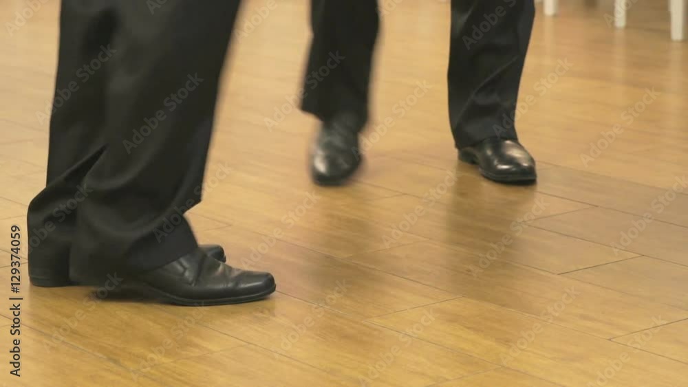 People dancing at the party indoors. People's feet close up People dancing at the party indoors. People's feet close up