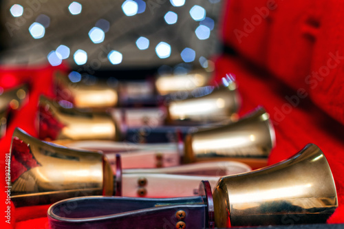 Set of gold handbells on table during concert. Christmas time