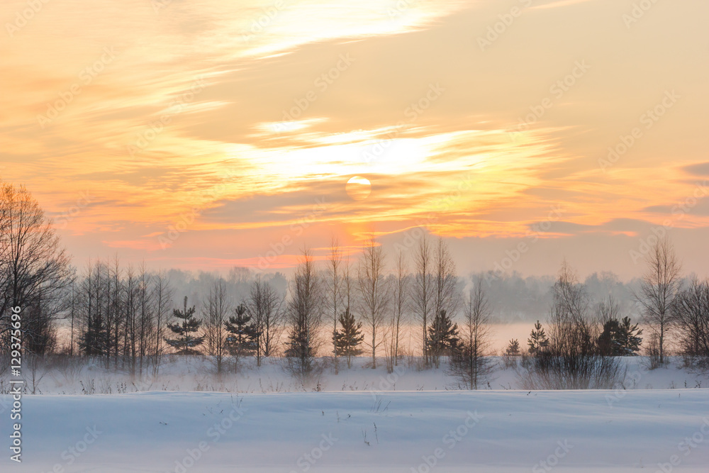 Sunset over the village and the winter fog. Sunset over the village and the winter fog.