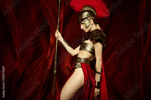 Woman in armour and helmet holding spear