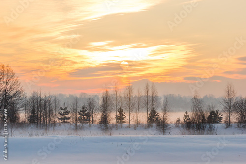 Sunset over the village and the winter fog. © fabrikanes