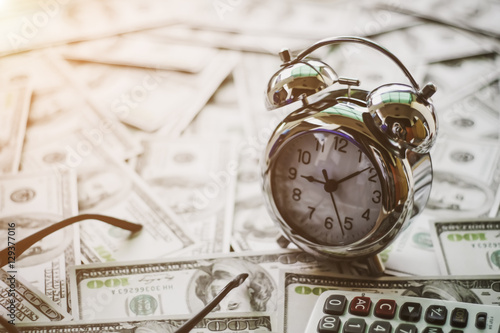 Close up of time and money with green bokeh background ,Business