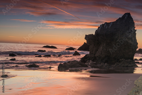 Fiery red sunset over the pacific Ocean at El Matador State beach near Malibu California © david