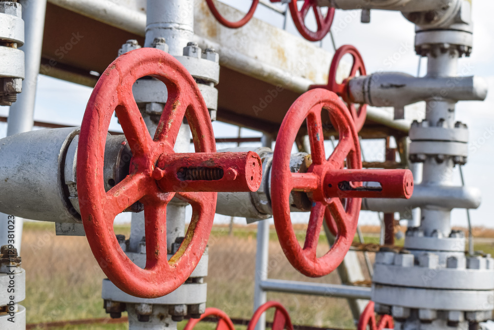 Shut-off valve valve with manual drive. Red steering wheel lock gate valve. oil well equipment Shut-off valve valve with manual drive. Red steering wheel lock gate valve. oil well equipment