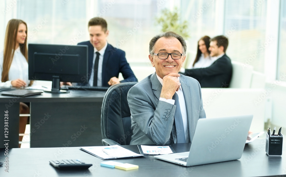 successful businessman on workplace with the laptop in a modern office successful businessman on workplace with the laptop in a modern office