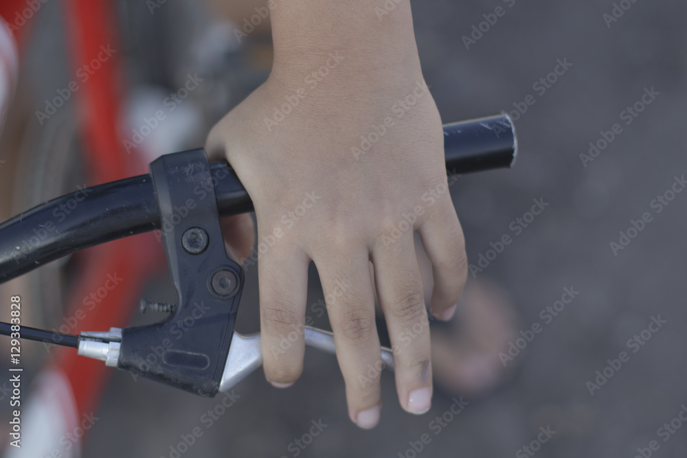 Close up bicycle rider's hands on a bicycle handlebar.